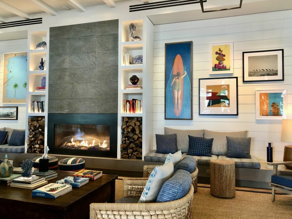 Lobby at Blue and white macrame ceiling art at The Seabird Resort Oceanside with fireplace and surf-inspired artwork