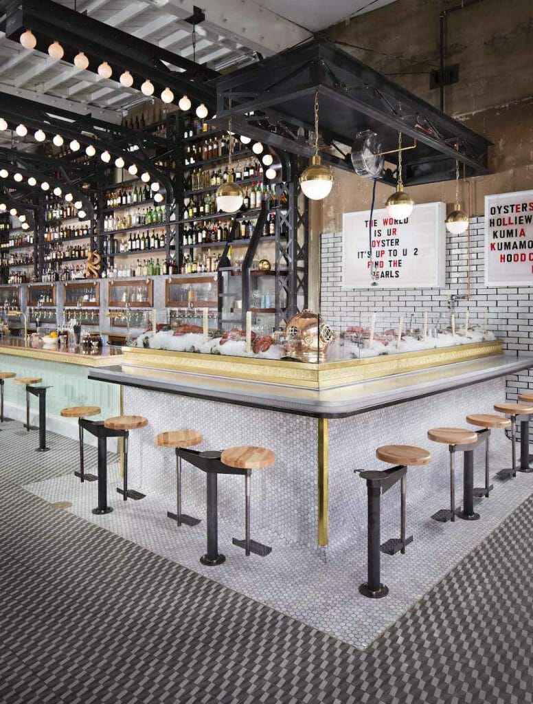 A monochrome bar in the corner of a restaurant, brightly lit with nobody around