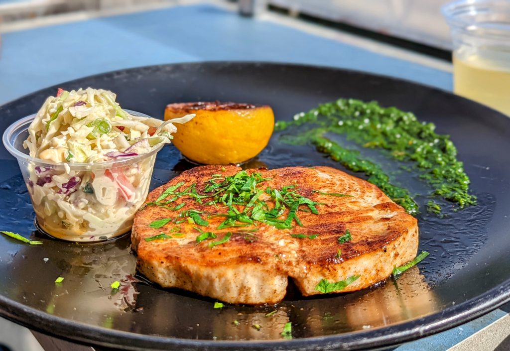 grilled swordfish fillet with coleslaw and charred lemon