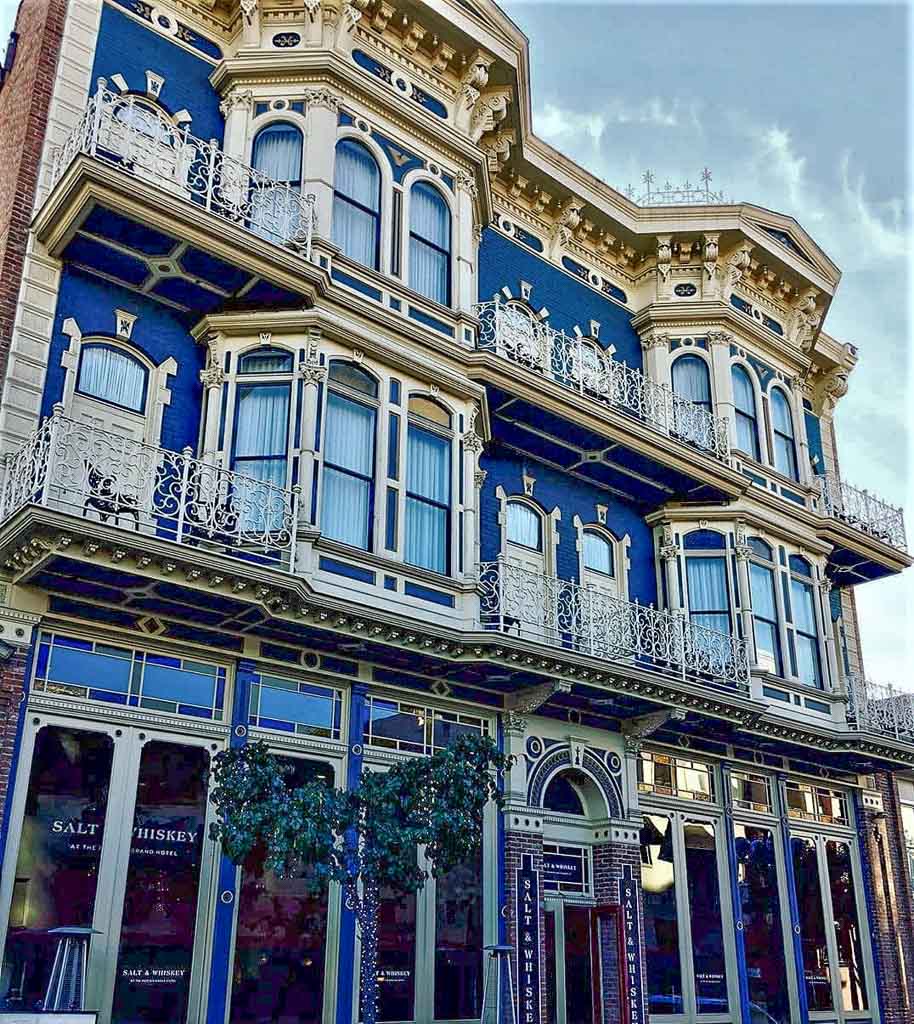 Facade of Horton Grand Hotel in San Diego - Victorian style building with white stucco and blue paint