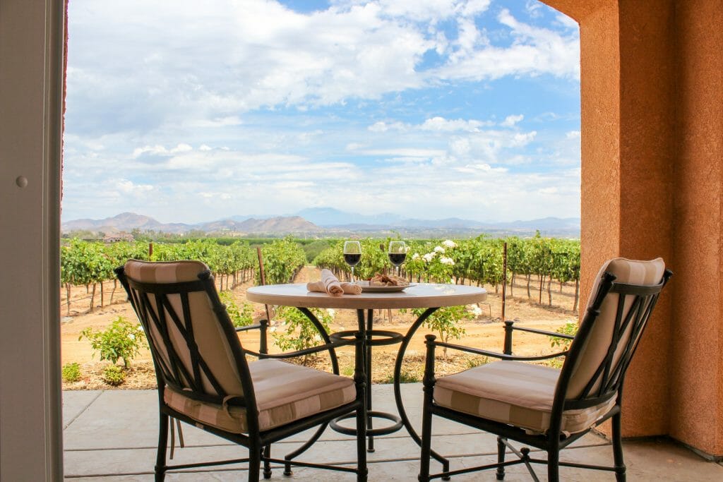 Two chairs and bistro table on terrace overlooking the vineyards in Temecula