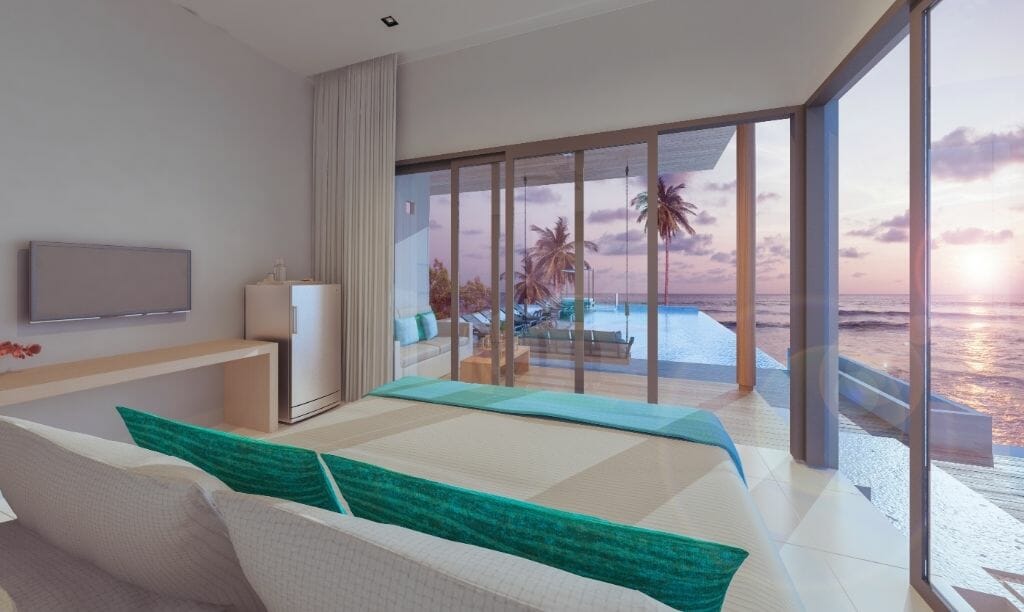 Mid-century modern furnished living room with large window front looking out to an infinity pool and the ocean