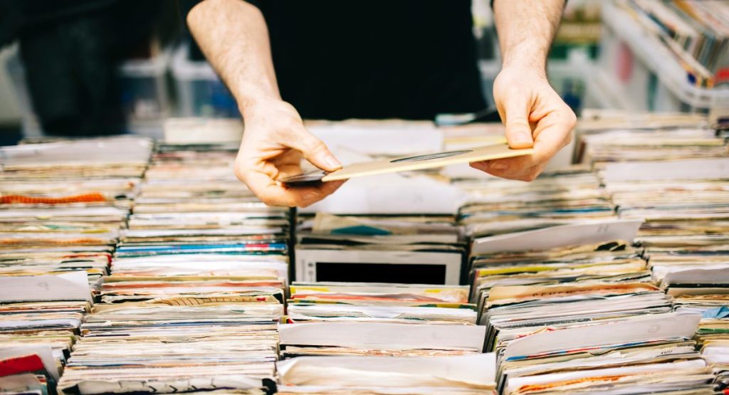 Person browsing vinyls in record store. Record Store San Diego.