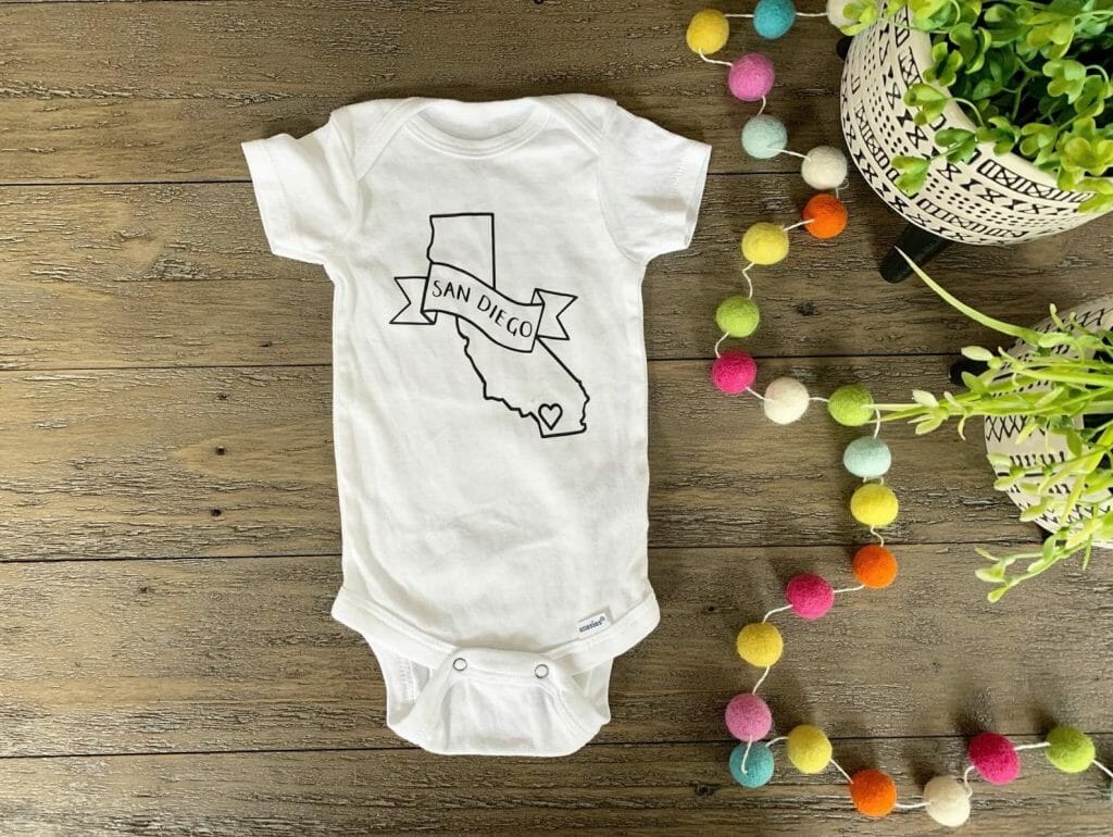 White baby onesie with black outline of California and San Diego print