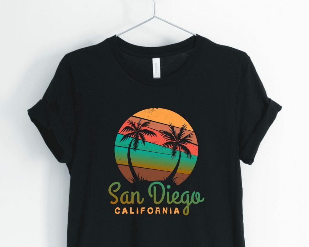 Black tshirt with vintage san Diego print: San Diego California Text and above a colorful circle with yellow red and green with black palm tree outlies