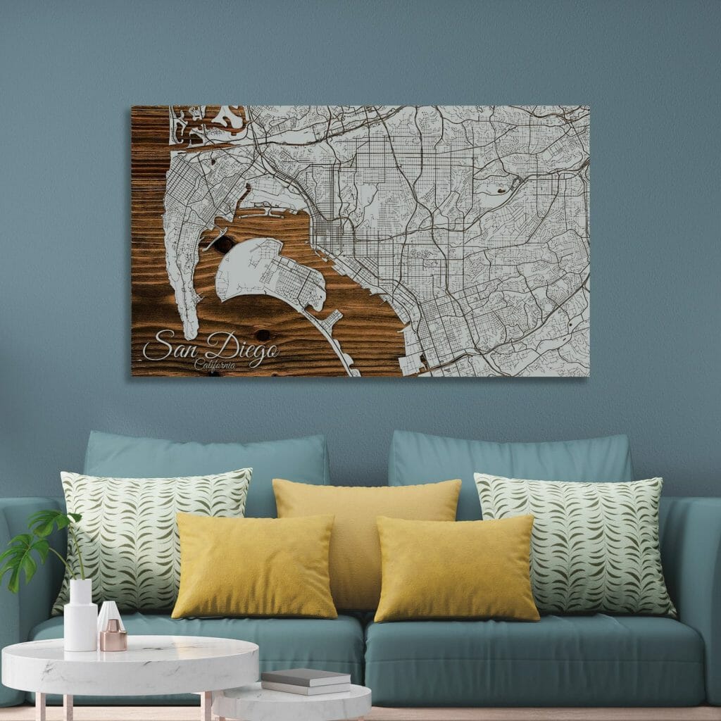 Living Room with teal couch and yellow cushions in front of grey wall, featuring a large wood map of San Diego