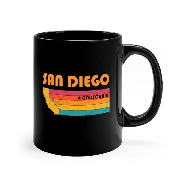 Black cup with Orange text San Diego and outline of California with a rainbow flag