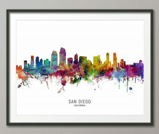 black framed picture on gray wall showing outline of San Diego colored with bright watercolors dripping down from the "horizon