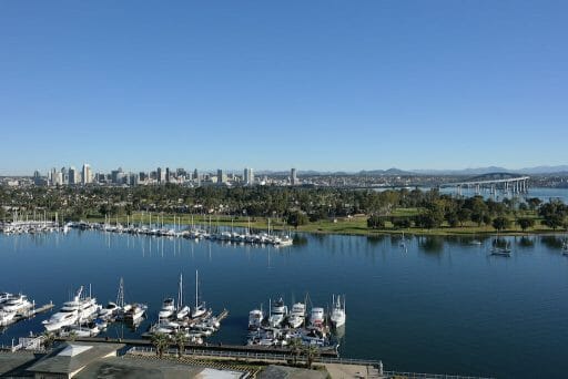 A panoramic view of Coronado bay marina, golf course and Coronado bay bridge with the backdrop of San Diego Downtown in California.