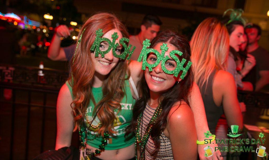 two young women at a party with green St Patricks Day Accessories