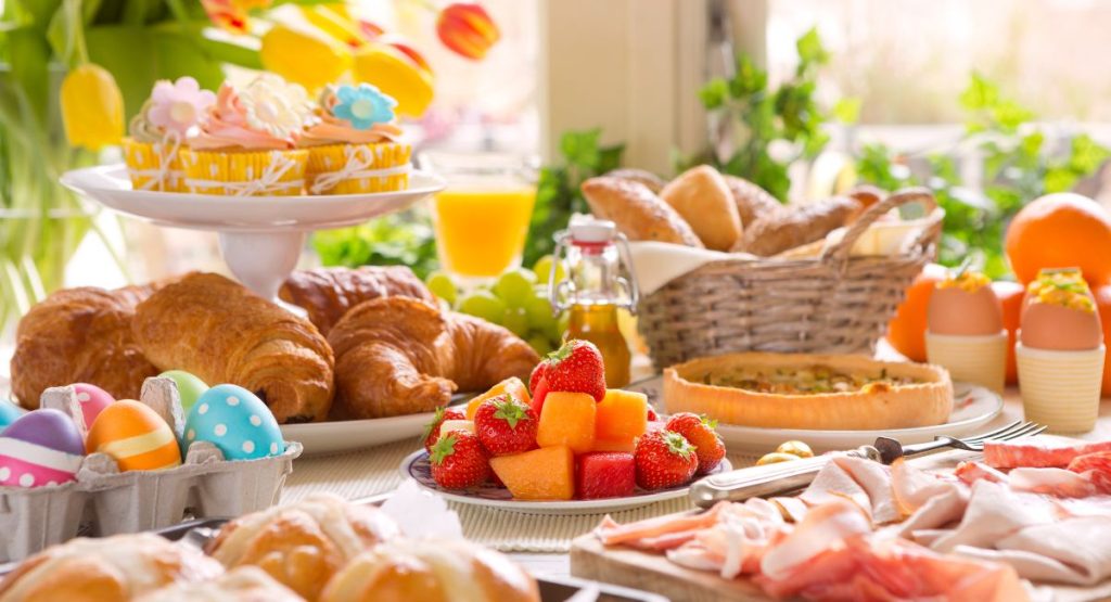 Easter Brunch San Diego - Table full of brunch food, easter eggs, tulips, fresh fruit, croissants and more.