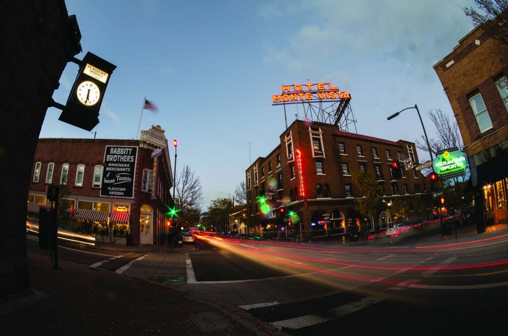 historic Brick buildings in downtown Flagstaff during dusk with long exposure car light trails on the street