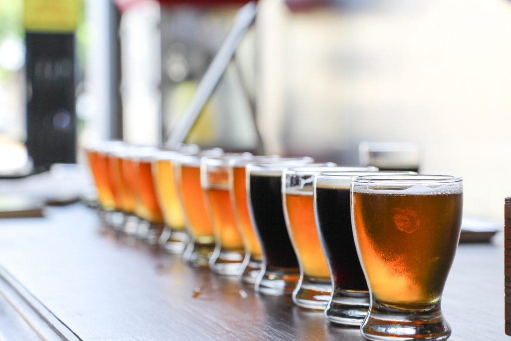 Flight of craft beer in various colors on a table