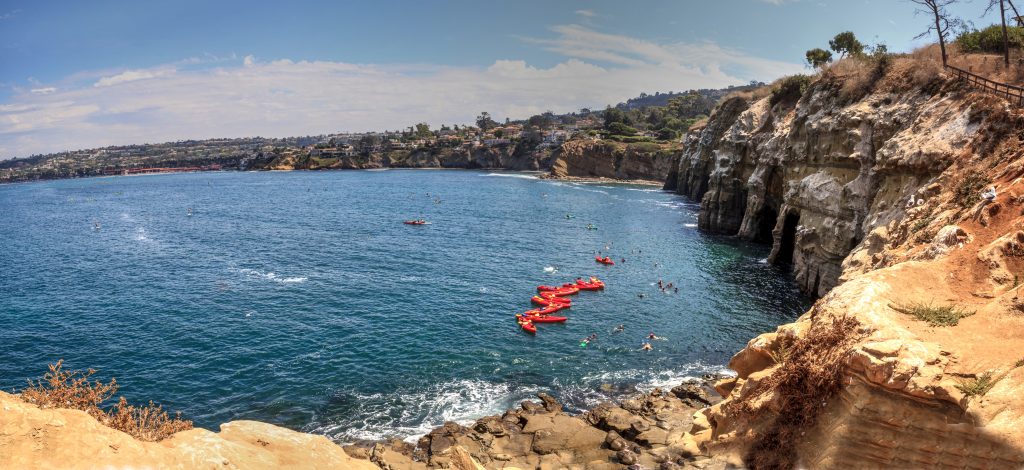 kayaks in the water near sand stone cliffs in La Jolla california - San Diego Valentine's Day