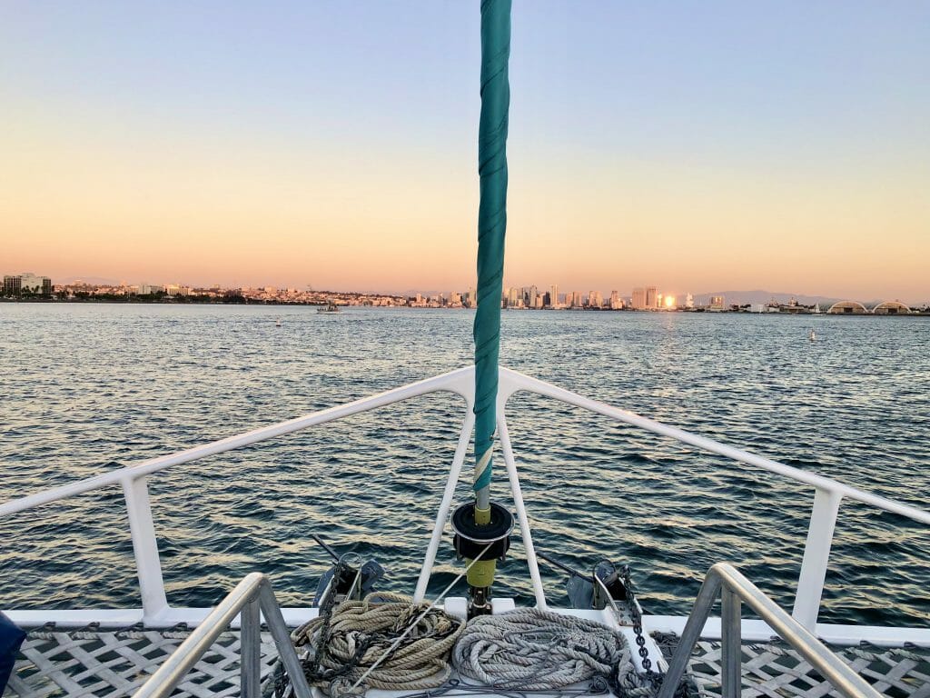 View of the San Diego Skyline during sunset with front of the Catamaran in the foreground