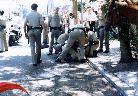 1986 police officers restraining a gay man from the san francisco lesbiangay freedom band,