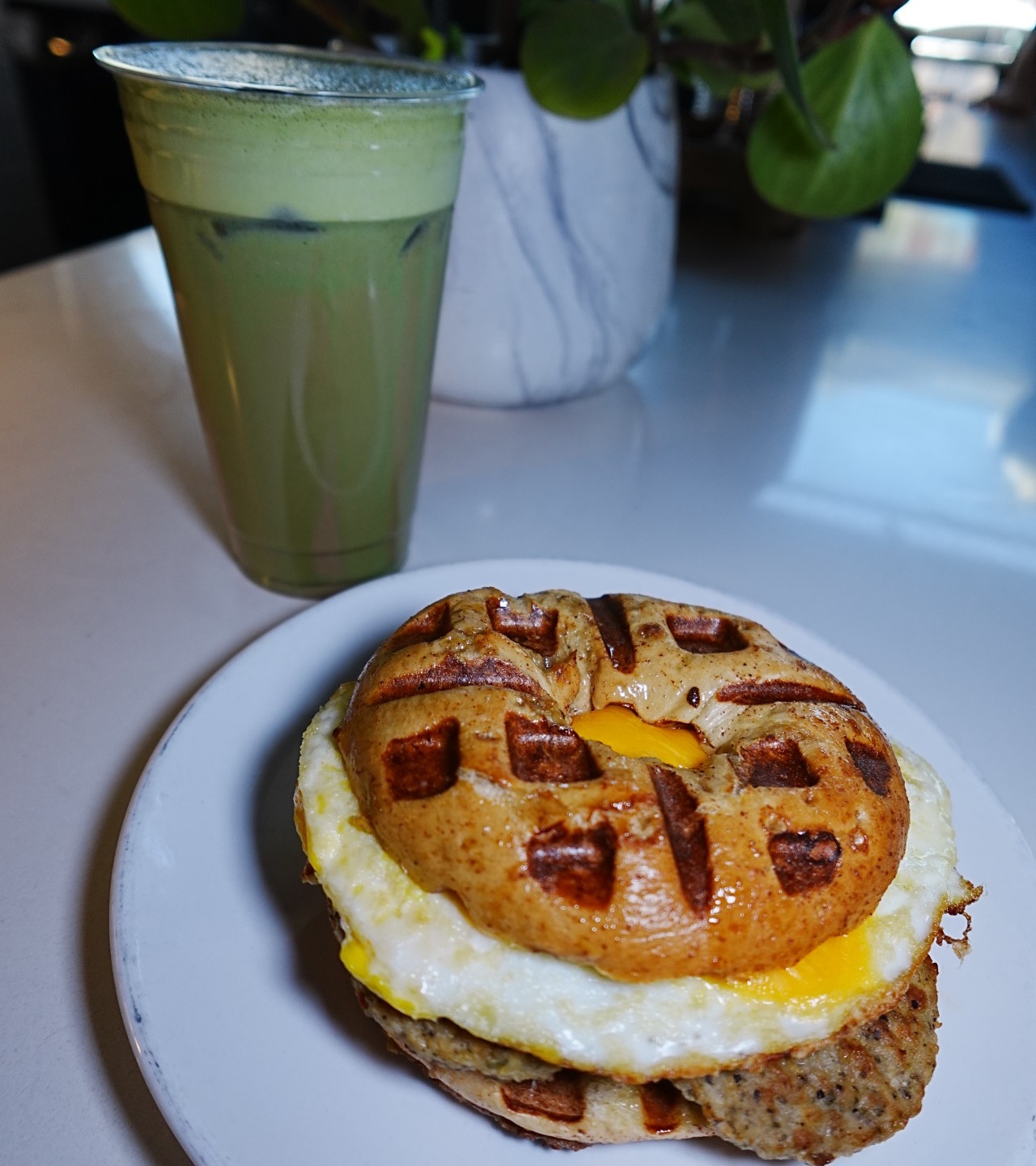 Shrek themed items including a green iced drink and waffle breakfast sandwich.