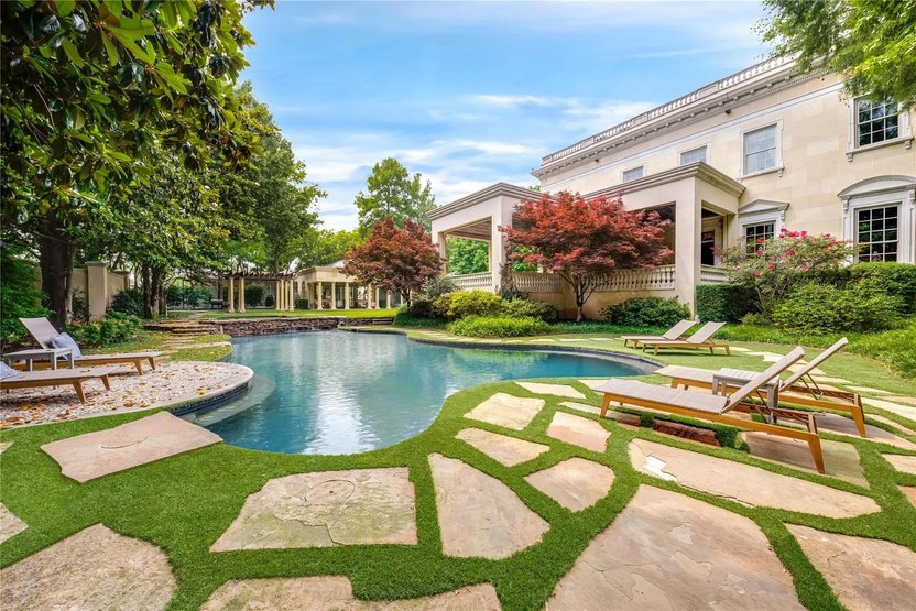 The swimming pool is on the other side of the pool house, and has easy access to the main house as well.