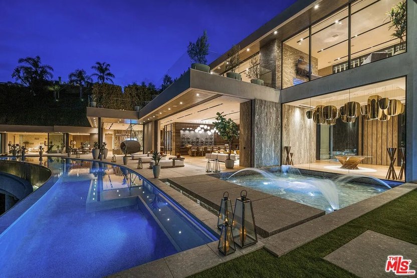 Many of the rooms in this house seamlessly open to the backyard with the 30-person jacuzzi and the 100-foot infinity pool.