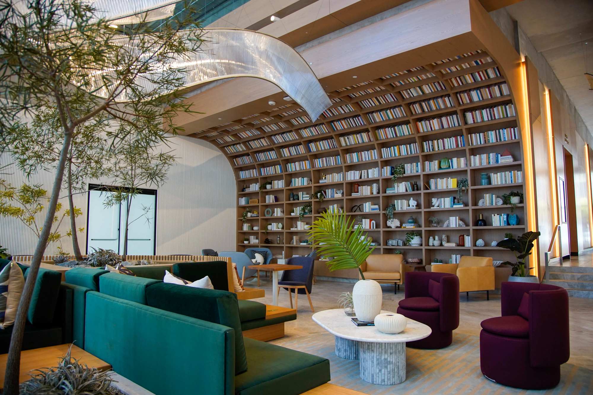 The main lobby area at West features a decorative library and wave-like sculpture. (Alejandro Tamayo / The San Diego Union-Tribune)