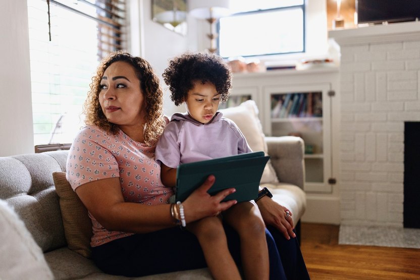 Mother sits with her son in the living room, expecting a tornado