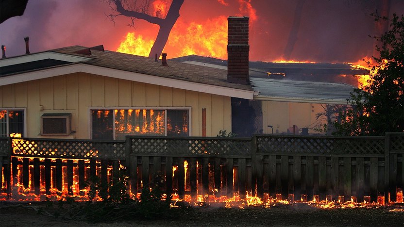 California wildfire burning home