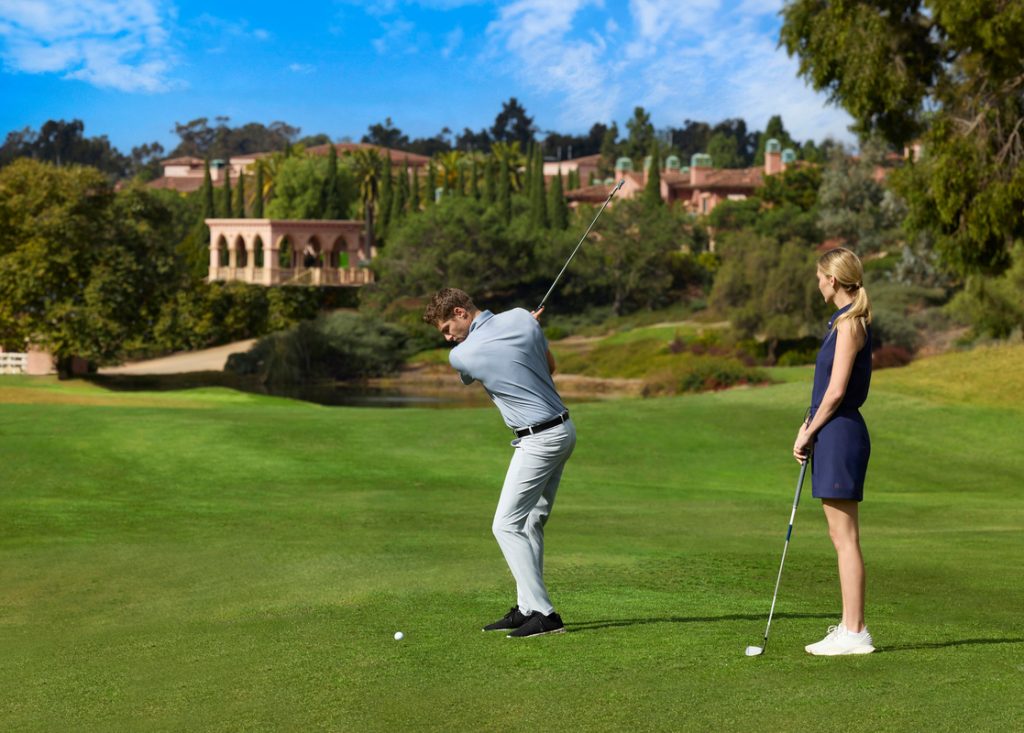 Man and woman playing golf at the Fairmont Grand Golf Club