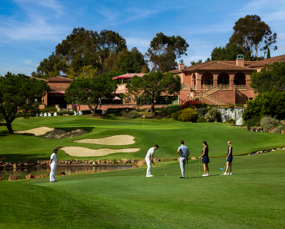 group of people playing golf at Man and woman playing golf at the Fairmont Grand Golf Club Del Mar