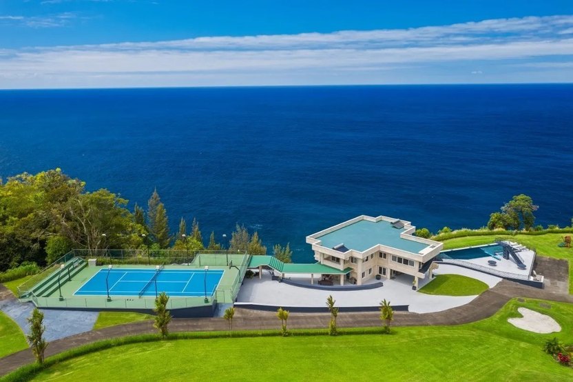 The tennis court and the Pacific Ocean beyond.