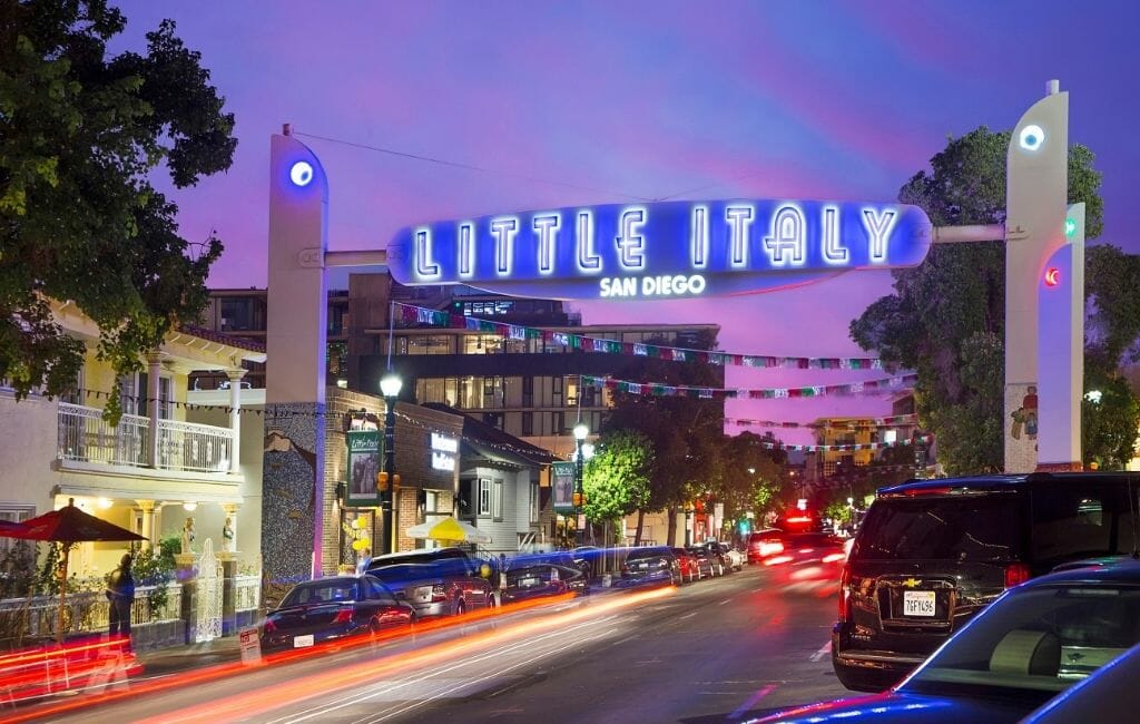 Neon sign "Little Italy" over street in Little Italy San Diego during sunset