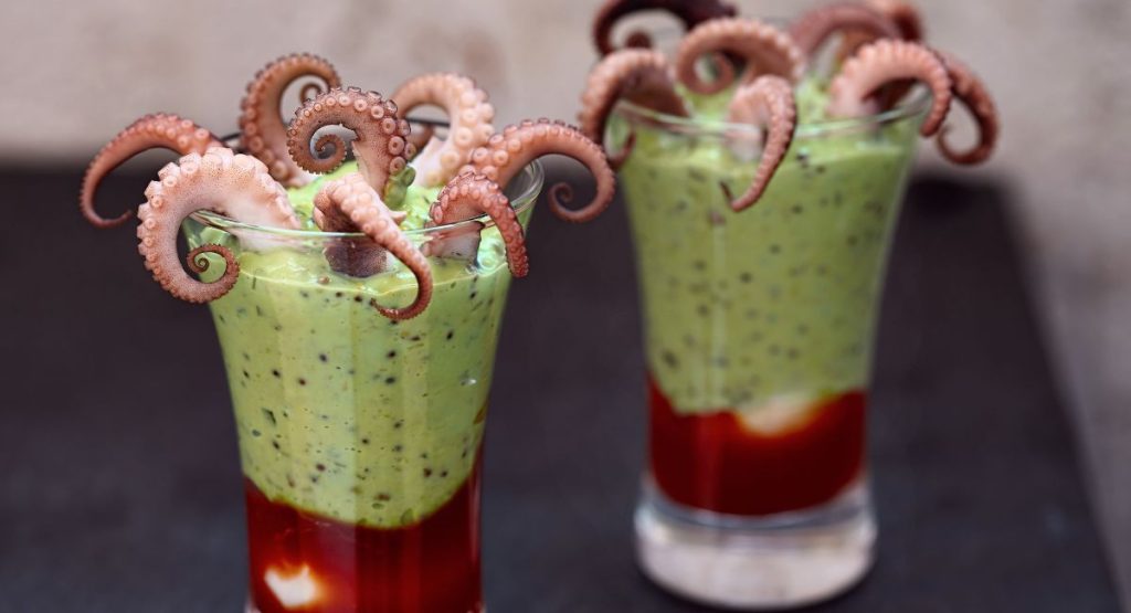 small glass with green cream with octopus tentacles coming out