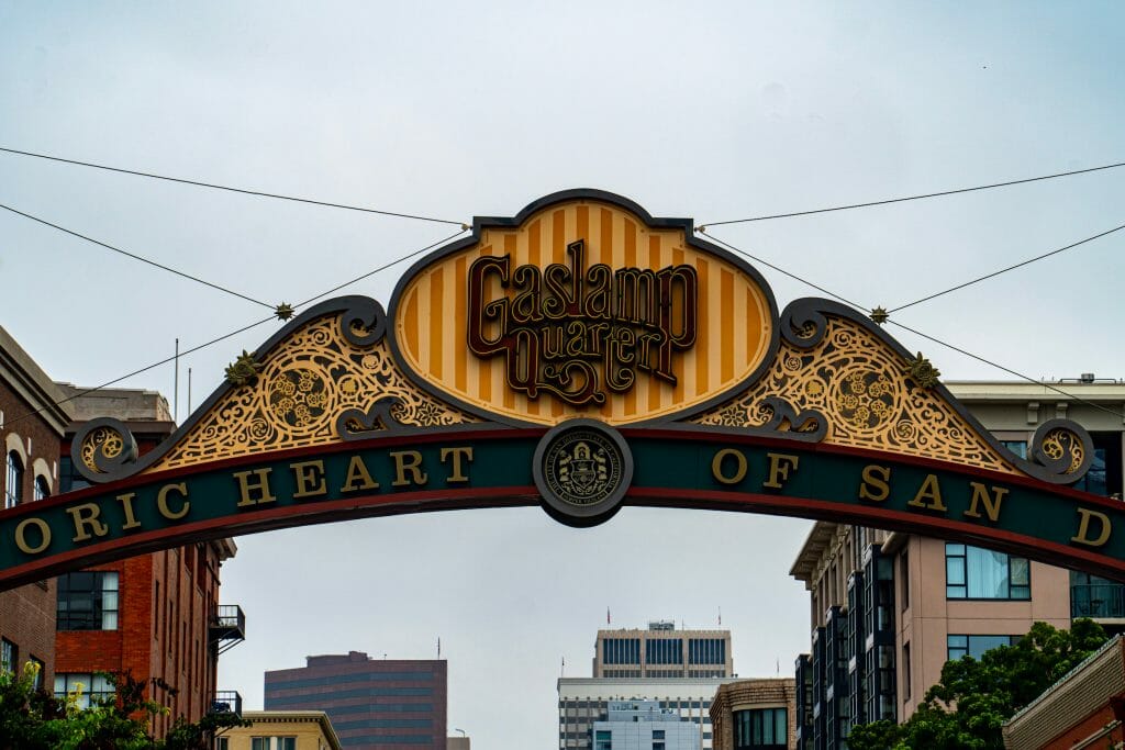 Sign of the Gaslamp Quarter at a close up with a gloomy sky as the background with building peaking up at the bottom