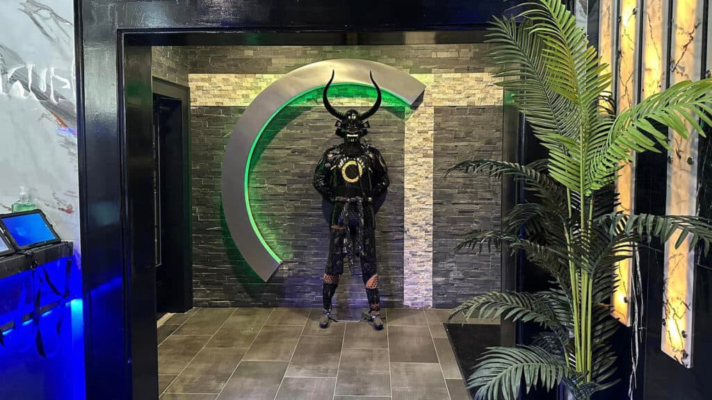 interior of a sushi restaurant. A large figure in armor is set at the entrance