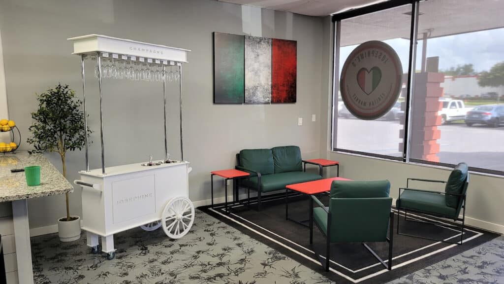 interior of a restaurant with a small white food cart in the lobby 