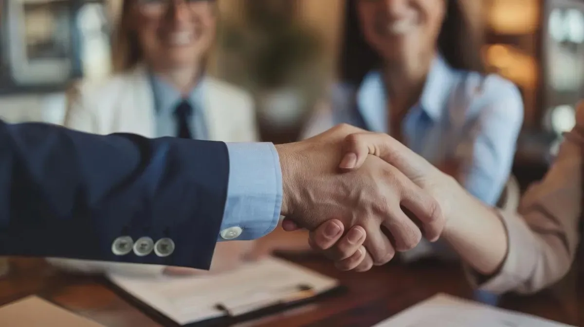 An attorney and a real estate agent shaking hands after closing a real estate deal