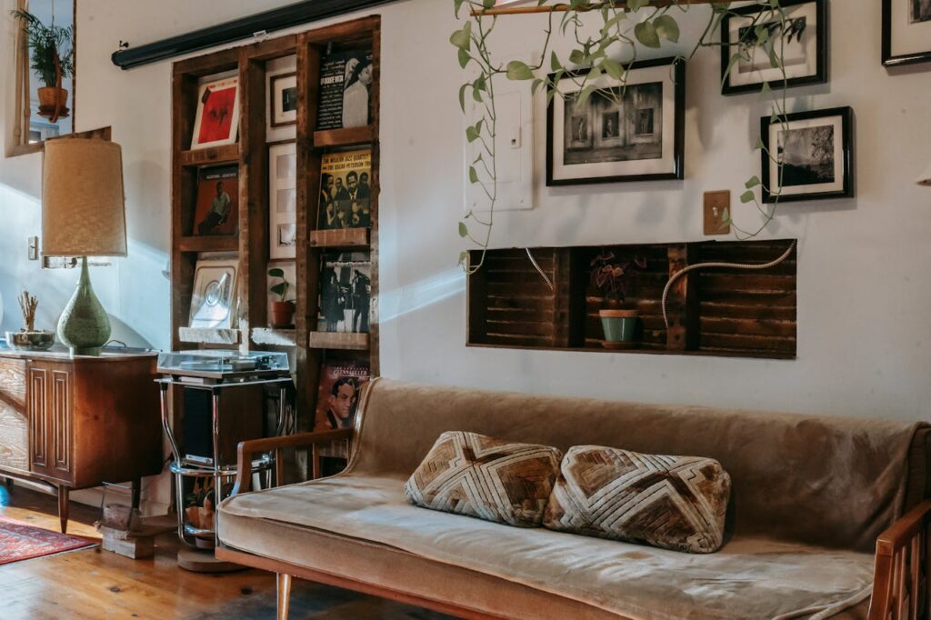 Shelf with vinyl records collection between sofa and wooden cabinet