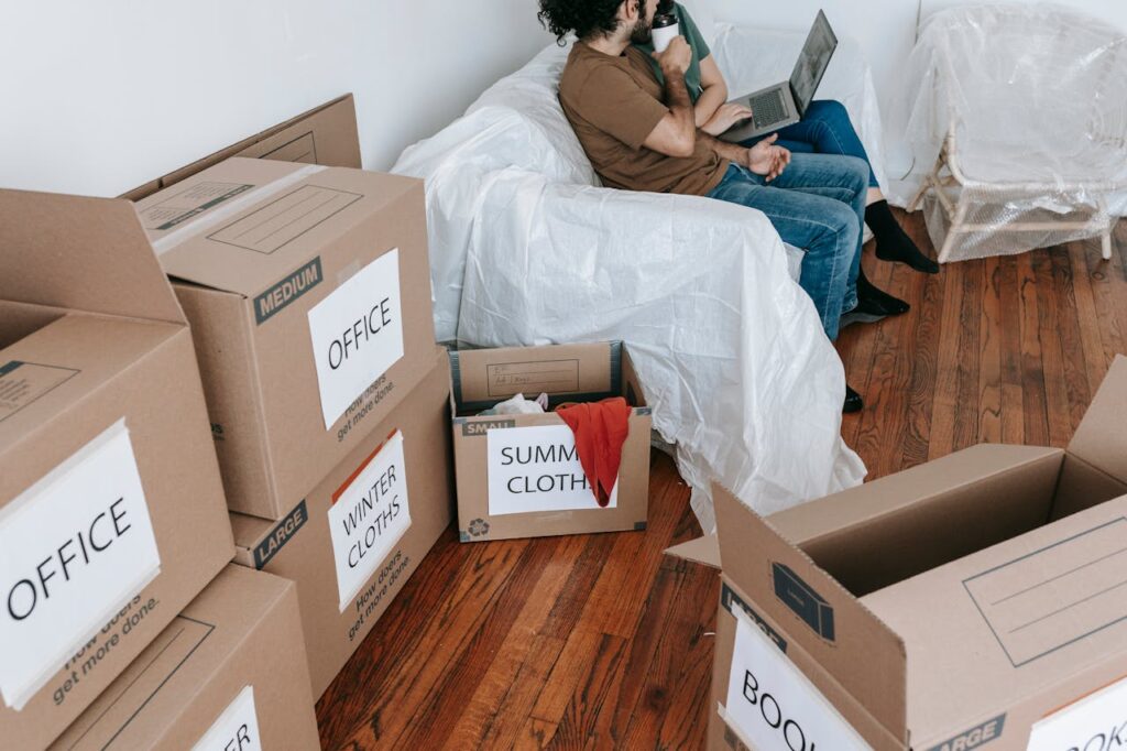 Couple sitting on a couch near brown boxes