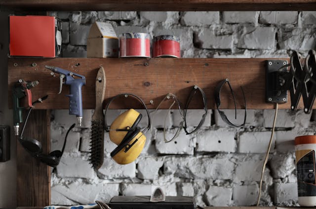 Various instruments hanging on wooden board in the garage