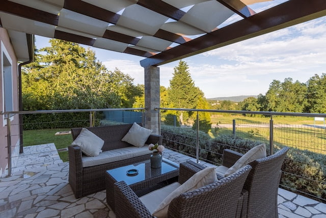 A cozy outdoor patio with sofas and pillows