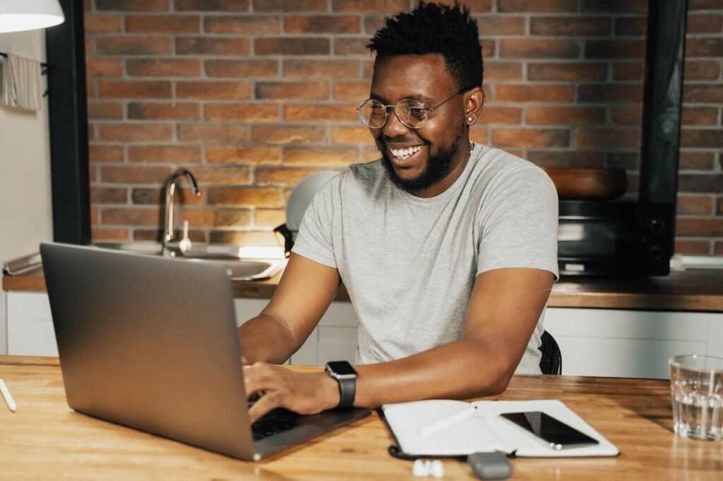 A man smiling while researching mortgage types