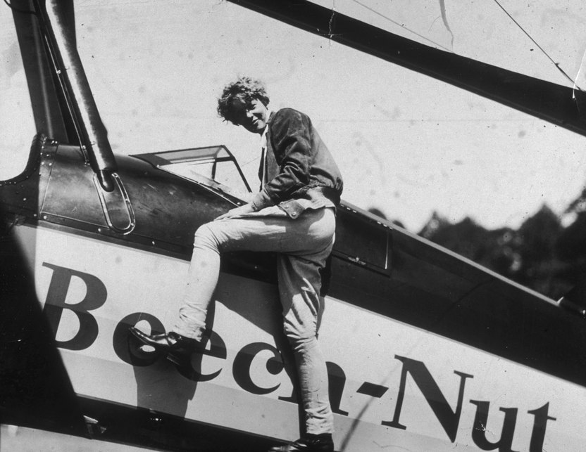 June 1931: American aviator Amelia Earhart (1898 - 1937) climbs into the cockpit of her airplane at Willow Grove, Pennsylvania, just before embarking on a trip to California. (Photo by New York Times Co./Getty Images)