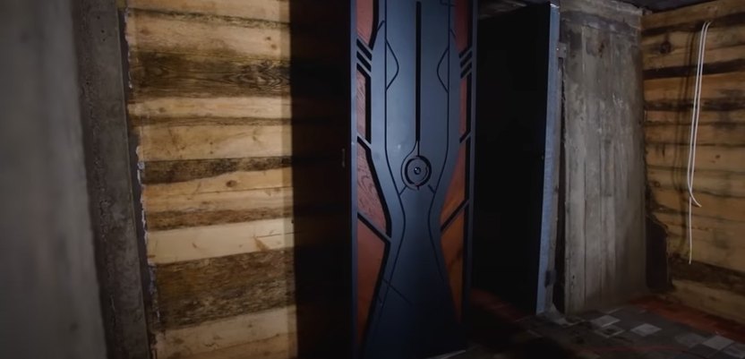 The door to the underground bunker is decorated with local folk designs.
