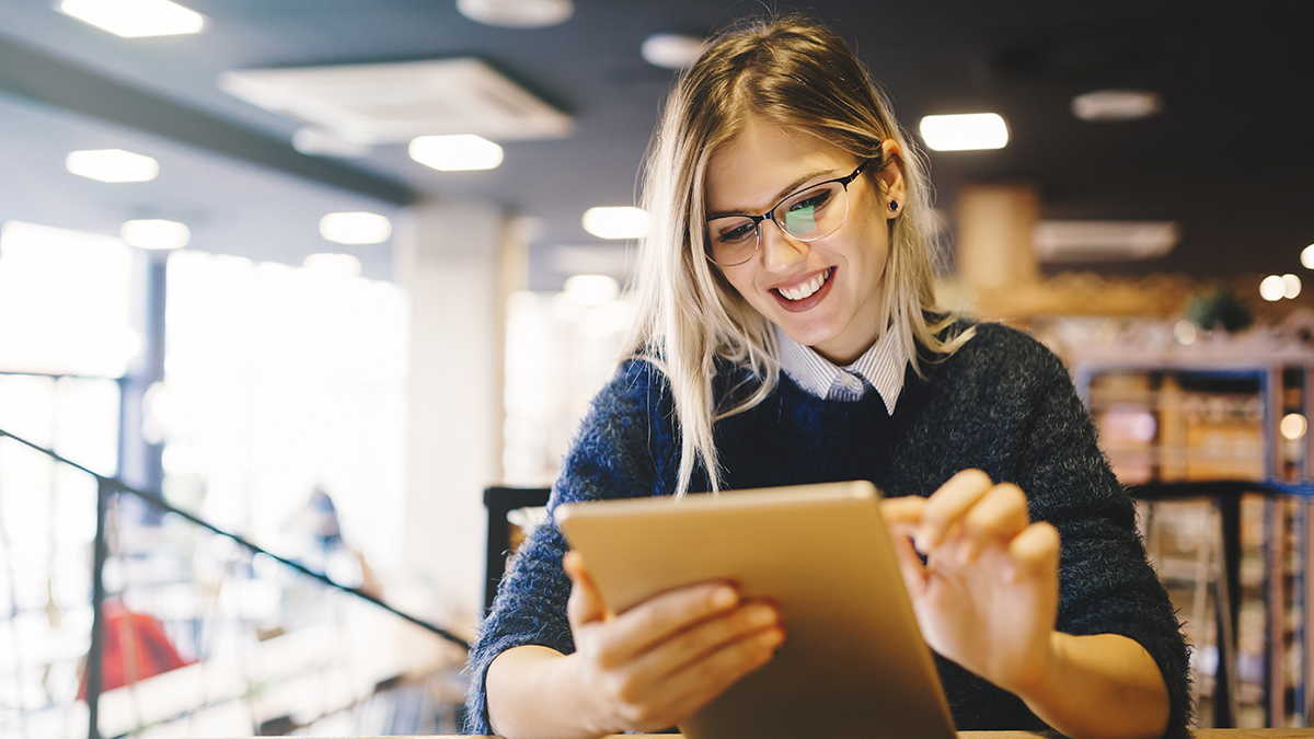 Smiling woman using a tablet computer