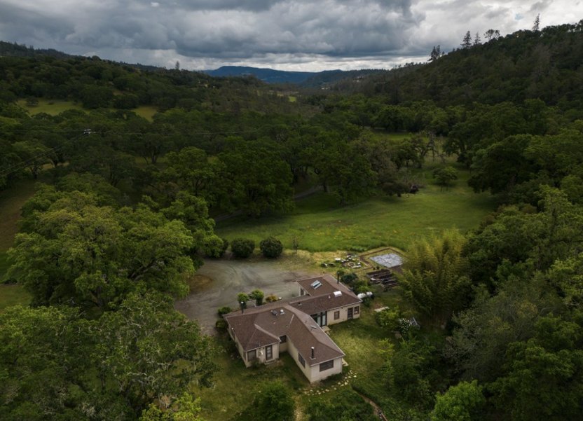 The Creekside House, built in the early 1900s, is situated on a prolific ranch garden.