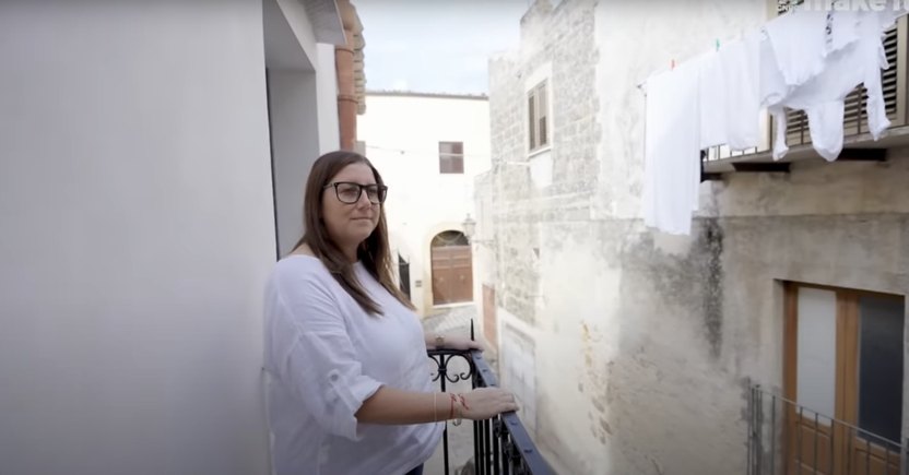 Meredith Tabbone enjoys the balcony of her newly completed Italian home.