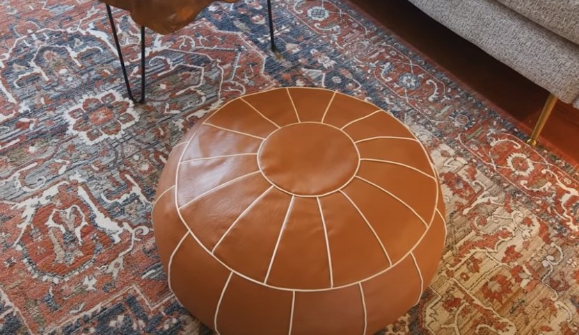 This attractive leather pouf does clever double duty.