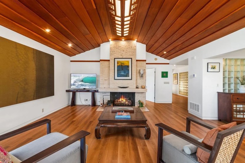 Gracefully coffered wood ceilings, myriad windows, and great rooms highlighted by fireplaces are typical of Lloyd Wright homes.