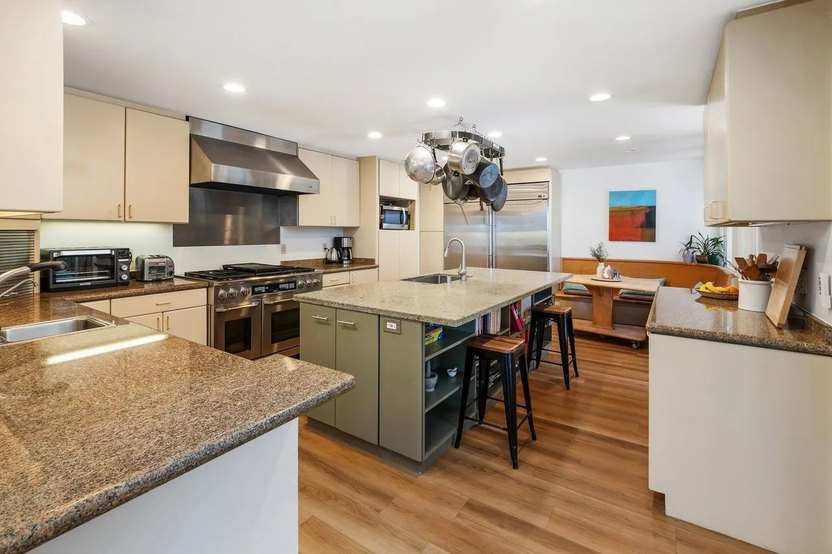 The kitchen has been updated with an island and stainless steel appliances.