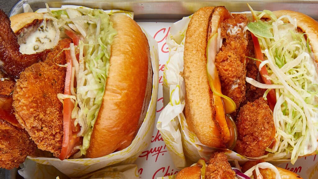 Multiple fried chicken sandwiches on a plate 