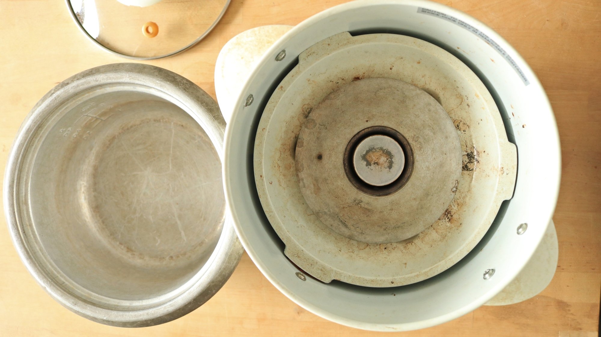 The inside of a rice cooker on a table.